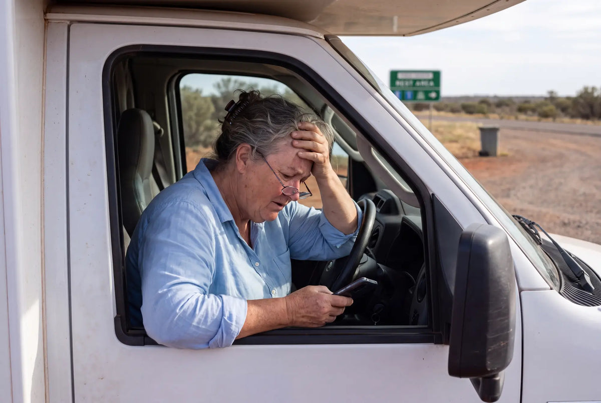 A woman driving a motorhome on an outback road